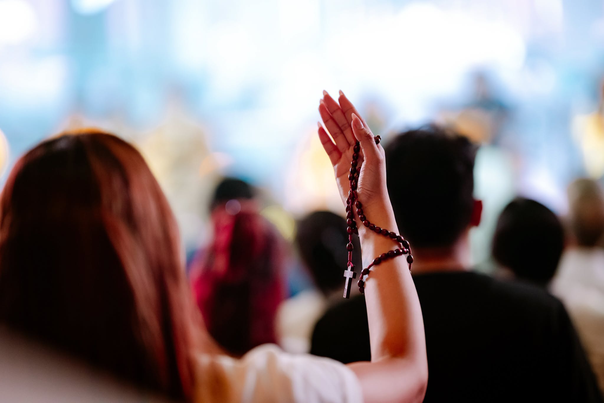 a woman holding a rosary
